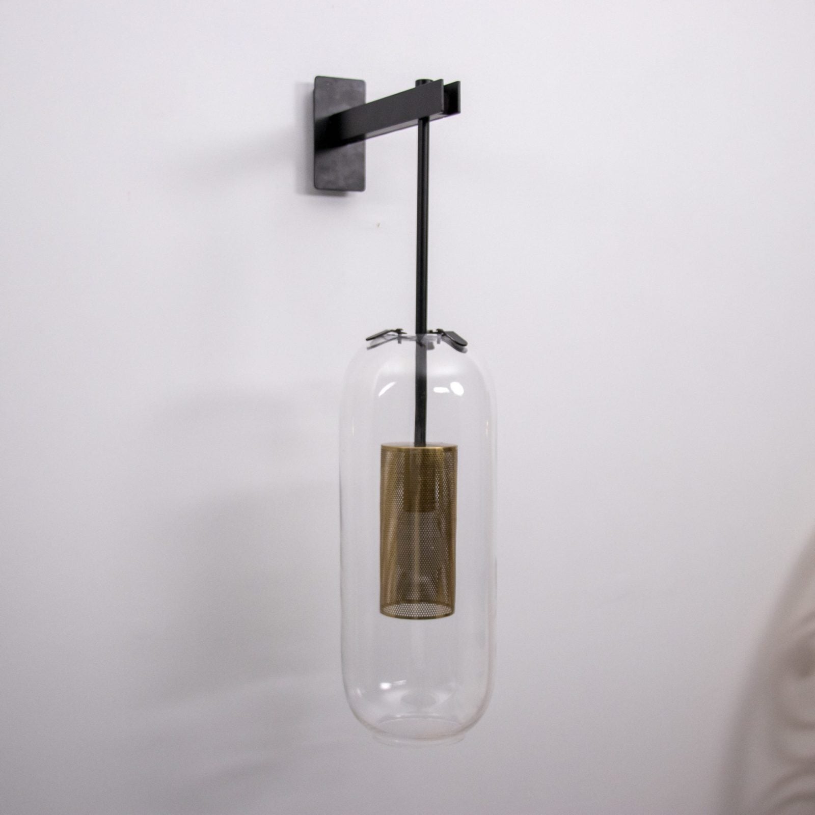 modern-vadim-glass-wall-sconce-with-perforated-metal-cage-and-brass-finish-for-luxury-interiors
