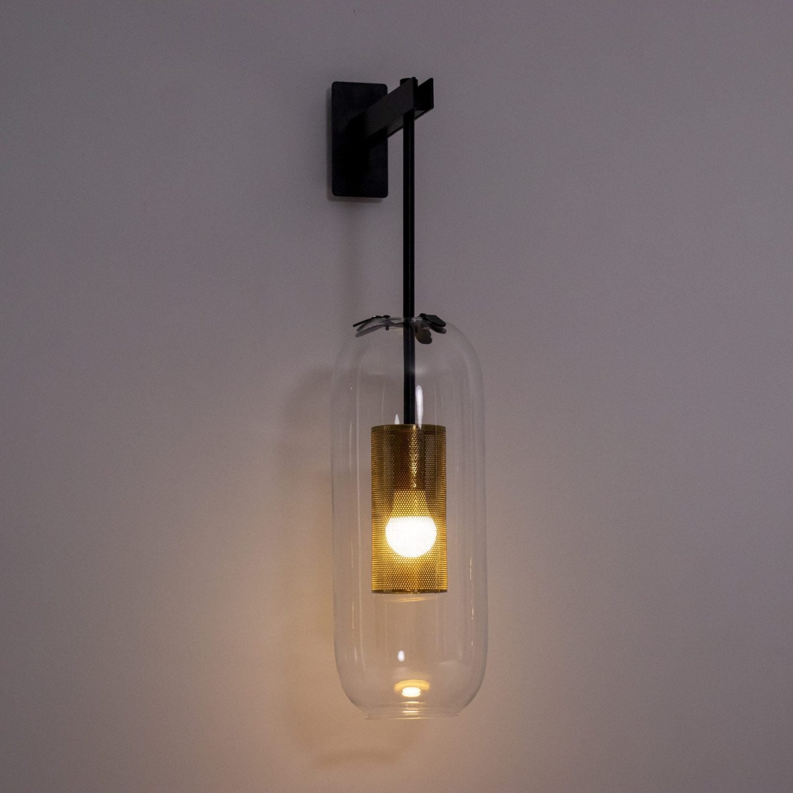 modern-vadim-glass-wall-sconce-with-perforated-metal-cage-and-brass-finish-for-luxury-interiors