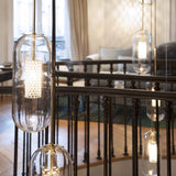 vadim-modern-glass-globe-pendant-light-with-gold-steel-rod-and-perforated-cage