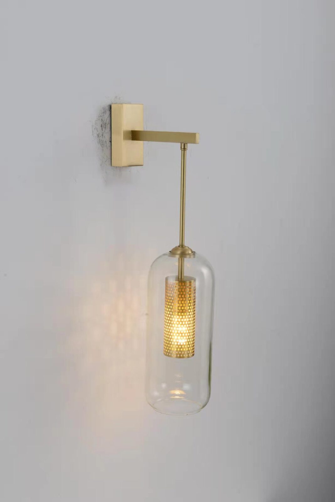 modern-vadim-glass-wall-sconce-with-perforated-metal-cage-and-brass-finish-for-luxury-interiors