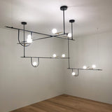 modern-minimalist-branch-chandelier-with-brass-bird-figures-and-white-glass-spheres