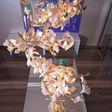 artistic-gingko-branch-chandelier-with-handcrafted-white-ceramic-leaves-and-gold-finish