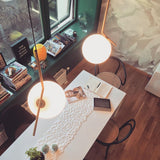 Contemporary Minimalist Equilibrium Glass Globe Pendant Light with Brass and Black Finishes