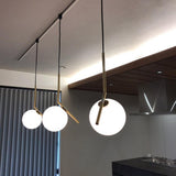 Contemporary Minimalist Equilibrium Glass Globe Pendant Light with Brass and Black Finishes