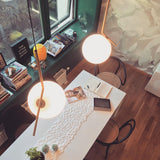 Contemporary Minimalist Equilibrium Glass Globe Pendant Light with Brass and Black Finishes