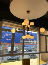 Mid Century Modern Brass Chandelier with Blown White Glass Globes and Bent Arms
