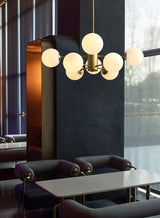 modern-asymmetrical-brass-chandelier-with-opal-glass-globe-shades-for-living-and-dining-rooms