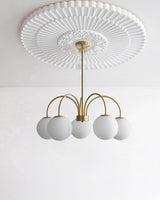 Modern Brass Globe Crown Chandelier with Elegant Curved Arms and Glass Ball Shades