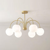 Modern Brass Globe Crown Chandelier with Elegant Curved Arms and Glass Ball Shades