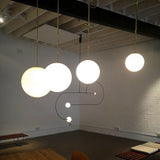 Modern Brass Rod Pendant Light with Spherical Mouth Blown Opal Glass Globe