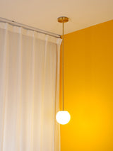 Modern Brass Rod Pendant Light with Spherical Mouth Blown Opal Glass Globe