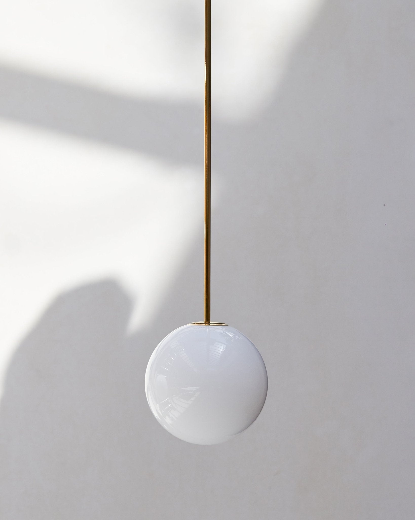 Modern Brass Rod Pendant Light with Spherical Mouth Blown Opal Glass Globe