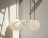 Modern Brass Rod Pendant Light with Spherical Mouth Blown Opal Glass Globe