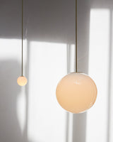 Modern Brass Rod Pendant Light with Spherical Mouth Blown Opal Glass Globe
