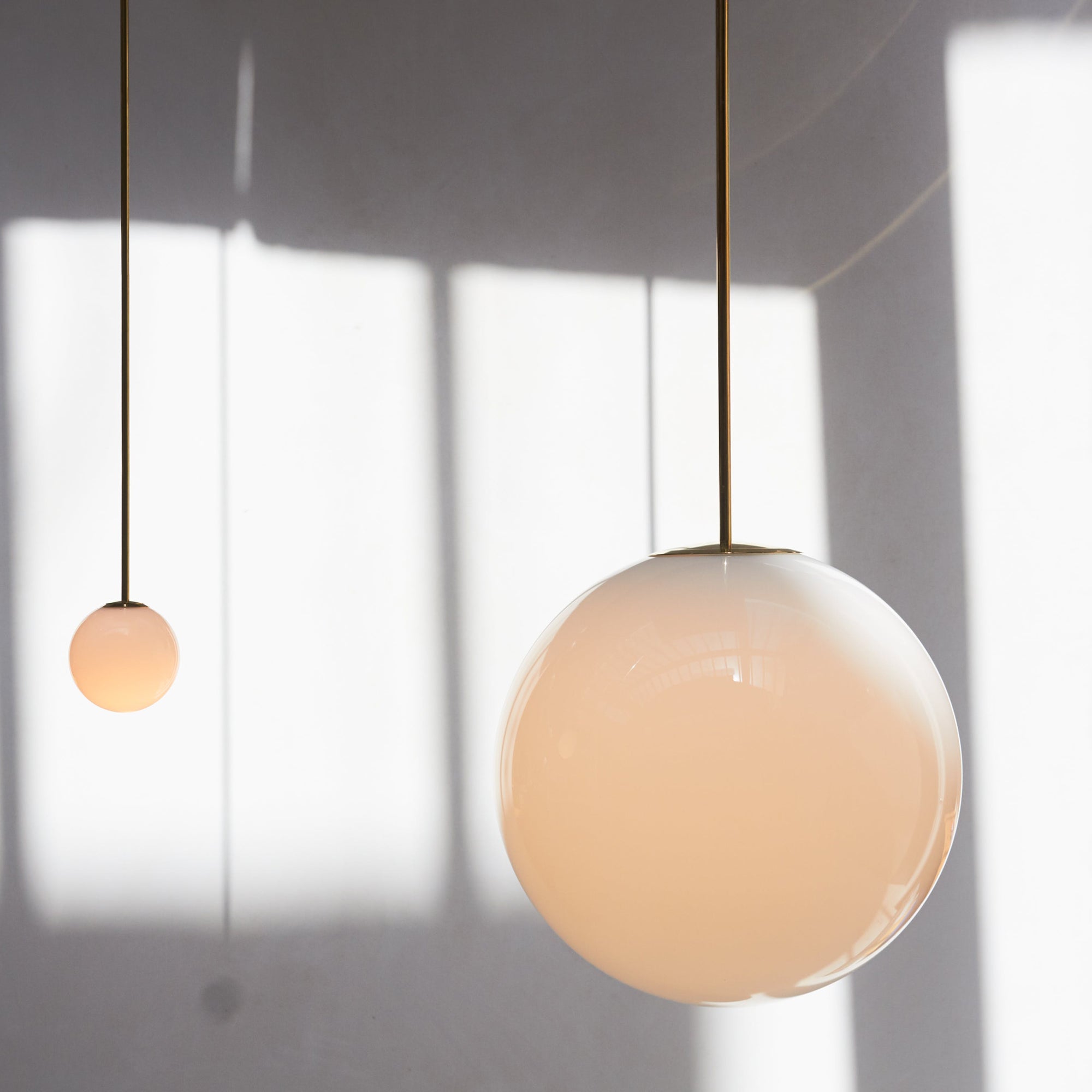 Modern Brass Rod Pendant Light with Spherical Mouth Blown Opal Glass Globe