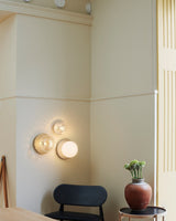 Modern Glass Globe Wall Sconce and Ceiling Lamp with Brass Metal Disc for Elegant Interior Decor