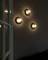 Modern Glass Globe Wall Sconce and Ceiling Lamp with Brass Metal Disc for Elegant Interior Decor