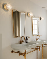 Modern Glass Globe Wall Sconce and Ceiling Lamp with Brass Metal Disc for Elegant Interior Decor