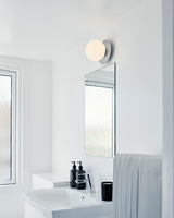 Modern Glass Globe Wall Sconce and Ceiling Lamp with Brass Metal Disc for Elegant Interior Decor