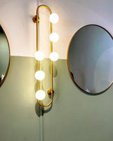 Modern Glass Globe Wall Sconce with Gold Metal Branch and Vertical Hanging Rod