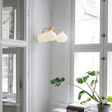 Modern Gold Metal and Opal Glass Globe Pendant Light for Contemporary Interiors