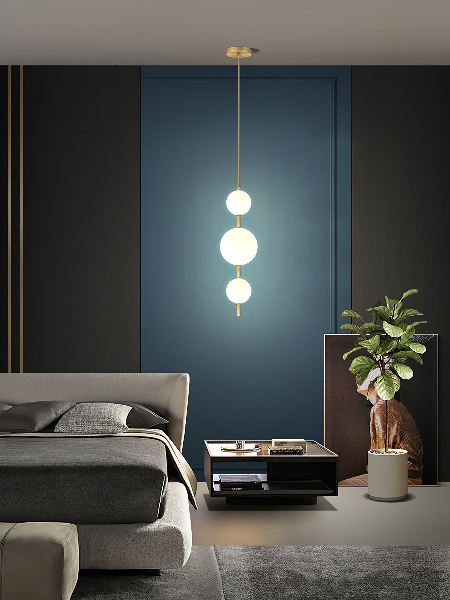 Modern Vertical Glass Globe Pendant Light in Black and Brass Finishes