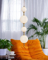 Modern Vertical Glass Globe Pendant Light in Black and Brass Finishes