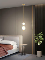 Modern Vertical Glass Globe Pendant Light in Black and Brass Finishes