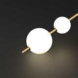 Modern Vertical Glass Globe Pendant Light in Black and Brass Finishes