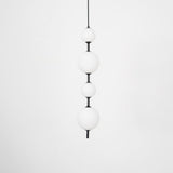 Modern Vertical Glass Globe Pendant Light in Black and Brass Finishes