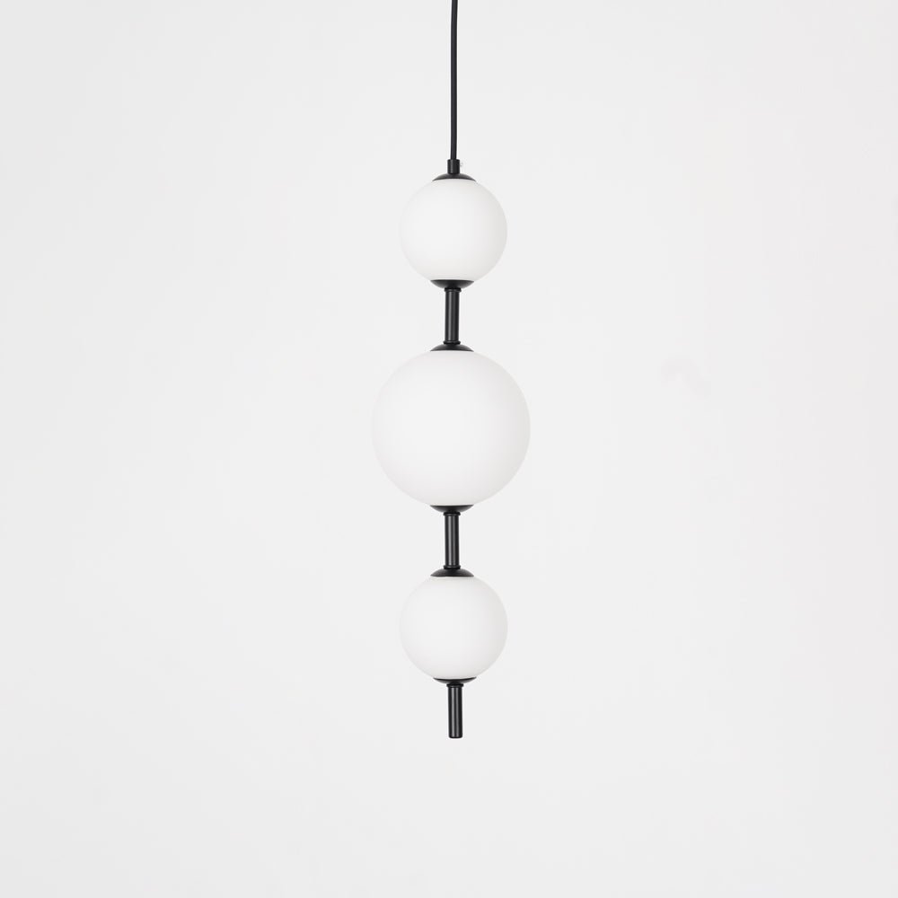 Modern Vertical Glass Globe Pendant Light in Black and Brass Finishes