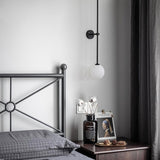 modern-brass-and-opal-glass-sphere-mobile-wall-sconce-lighting-for-indoor-spaces