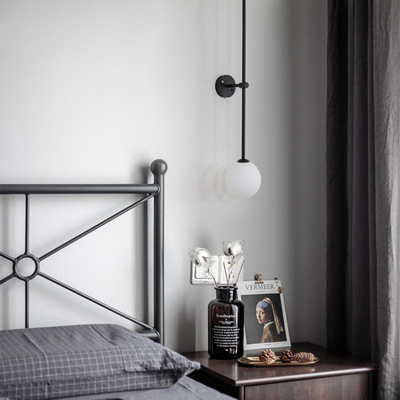 modern-brass-and-opal-glass-sphere-mobile-wall-sconce-lighting-for-indoor-spaces