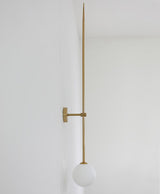 modern-brass-and-opal-glass-sphere-mobile-wall-sconce-lighting-for-indoor-spaces