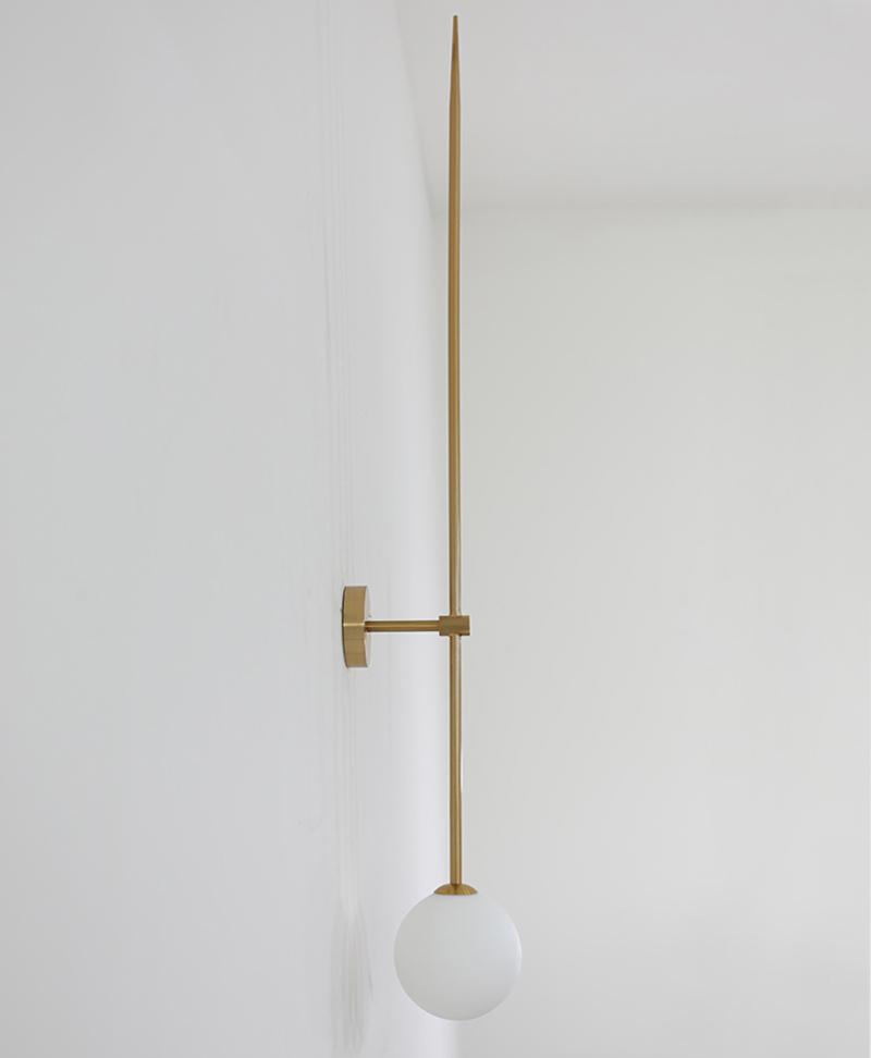 modern-brass-and-opal-glass-sphere-mobile-wall-sconce-lighting-for-indoor-spaces