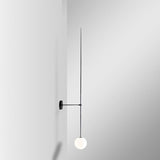 modern-brass-and-opal-glass-sphere-mobile-wall-sconce-lighting-for-indoor-spaces