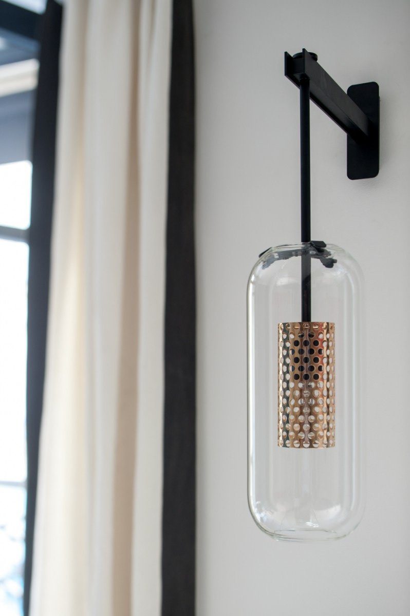 modern-vadim-glass-wall-sconce-with-perforated-metal-cage-and-brass-finish-for-luxury-interiors