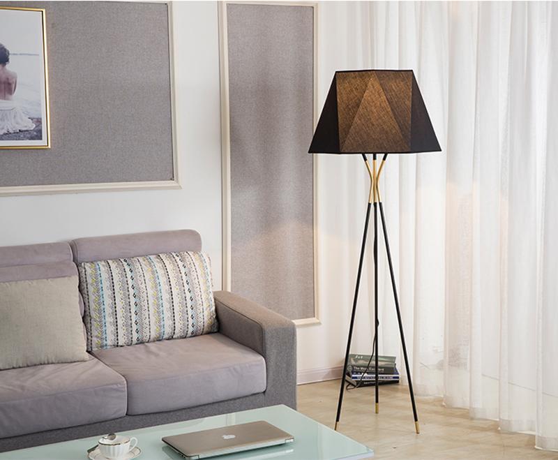 modern-solitaire-tripod-floor-lamp-with-black-polygonal-cloth-shade-and-brass-accents