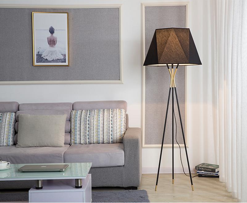 modern-solitaire-tripod-floor-lamp-with-black-polygonal-cloth-shade-and-brass-accents