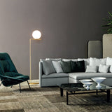 modern-industrial-gold-standing-lamp-with-white-glass-globe-shade-and-foot-switch