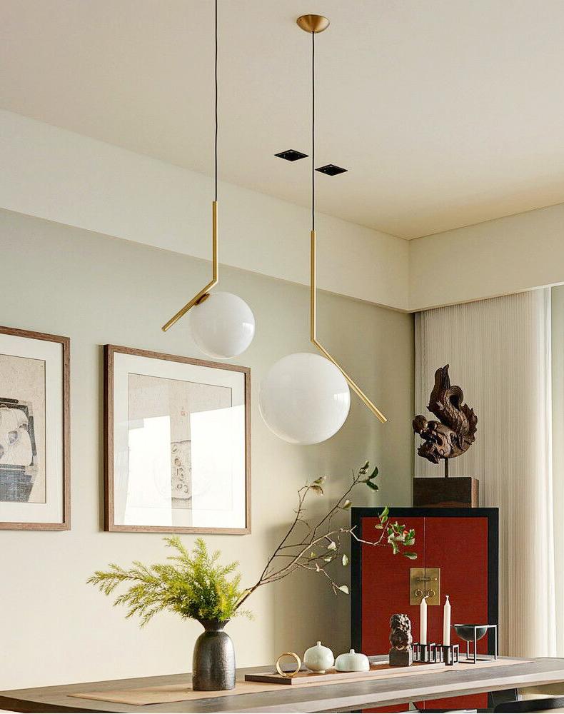 modern-brass-and-opal-glass-globe-pendant-light-minimalist-baton-design-hanging-lamp