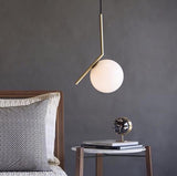 modern-brass-and-opal-glass-globe-pendant-light-minimalist-baton-design-hanging-lamp