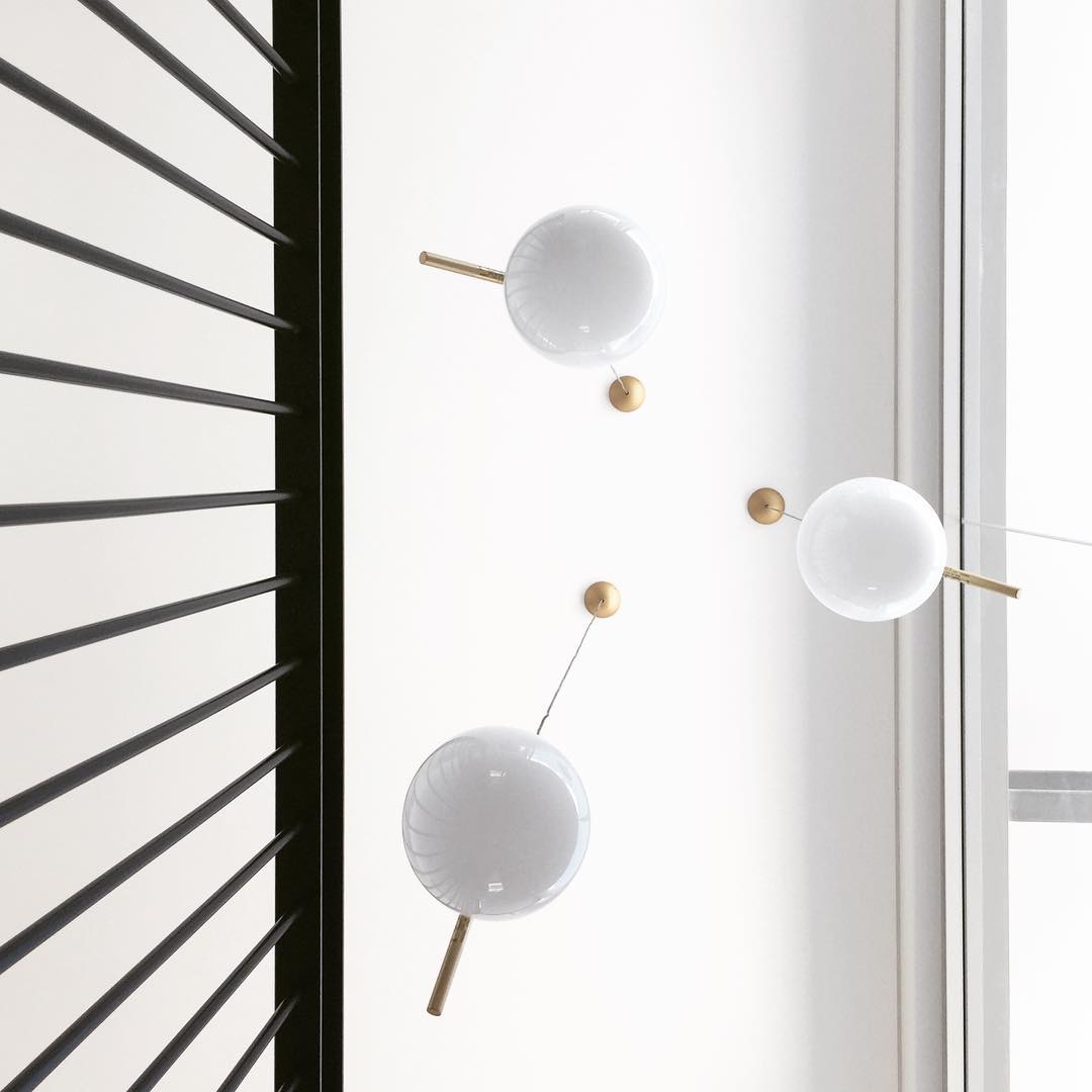 modern-brass-and-opal-glass-globe-pendant-light-minimalist-baton-design-hanging-lamp