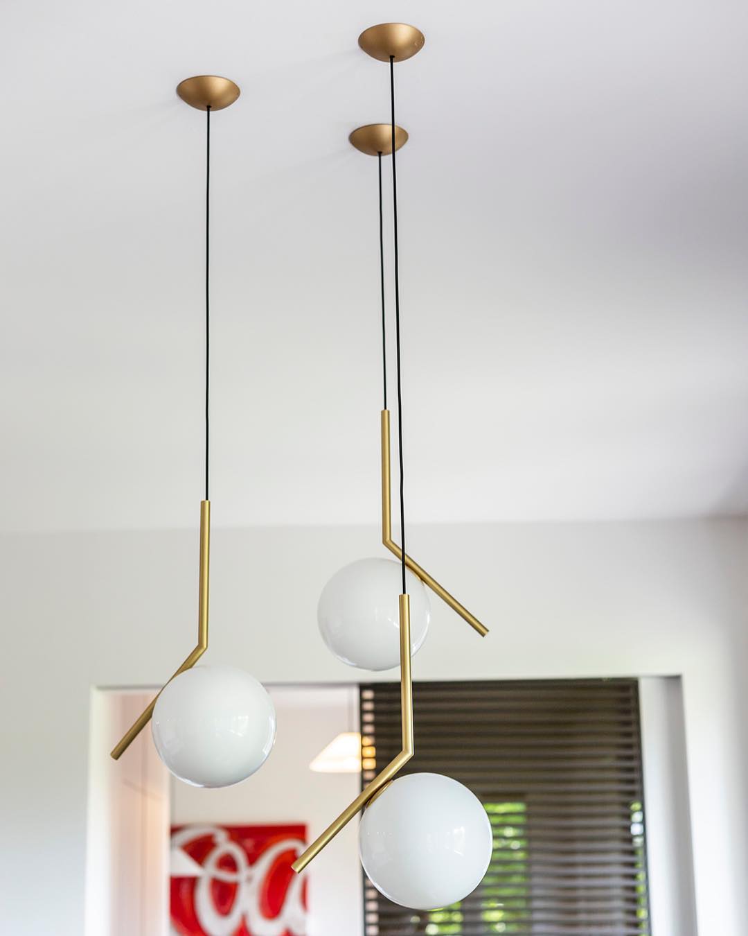 modern-brass-and-opal-glass-globe-pendant-light-minimalist-baton-design-hanging-lamp