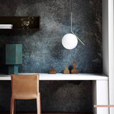 modern-brass-and-opal-glass-globe-pendant-light-minimalist-baton-design-hanging-lamp