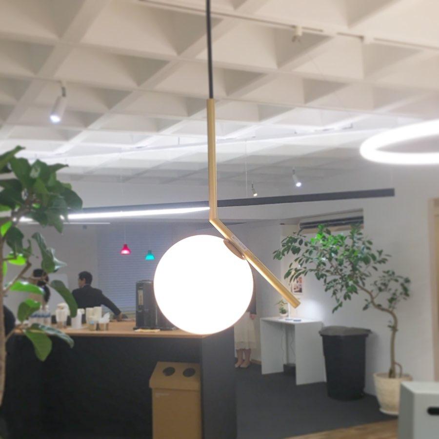 modern-brass-and-opal-glass-globe-pendant-light-minimalist-baton-design-hanging-lamp