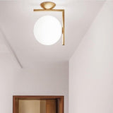 modern-opal-blown-glass-wall-sconce-with-elegant-brass-finish-round-globe-lighting