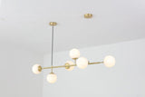 contemporary-multi-glass-globe-pendant-light-with-round-orb-shades-and-polished-brass-frame