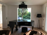 modern-solitaire-tripod-floor-lamp-with-black-polygonal-cloth-shade-and-brass-accents