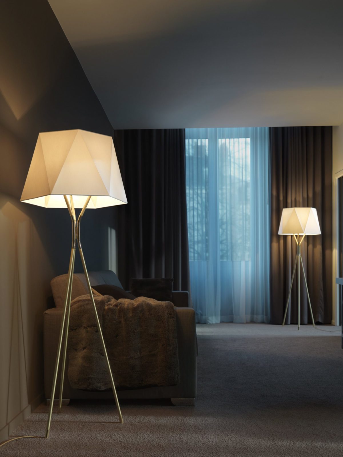 modern-solitaire-tripod-floor-lamp-with-black-polygonal-cloth-shade-and-brass-accents